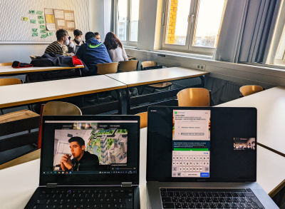 A classroom during an accessibility workshop with opened laptops and students conducting a mobile testing session